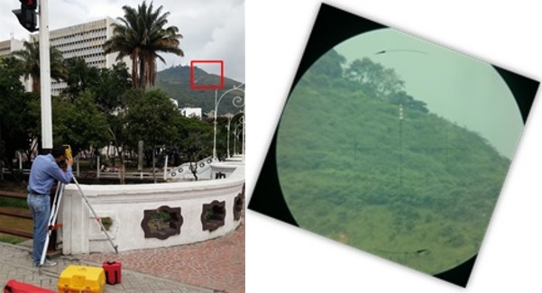 Fotografía en la que se muestra una persona ubicada en el punto de la Red de Control Geodésico cercano a la iglesia La Ermita, con una estación de topografía, mirando hacía la señal de azimuth que se encuentra ubicada en el Cerro de Las Tres Cruces.